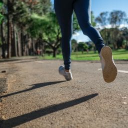 Close up of woman jogging outside.
