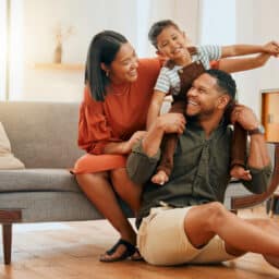 Family on a couch looking happy
