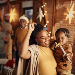Family celebrating the new year, woman holding her child.