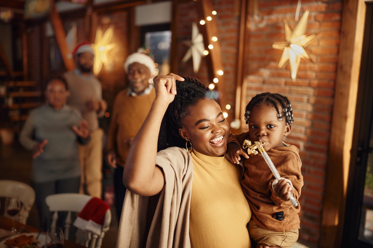 Family celebrating the new year, woman holding her child