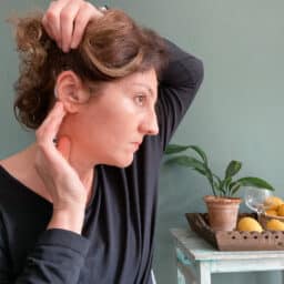 Woman looking at her hearing aid