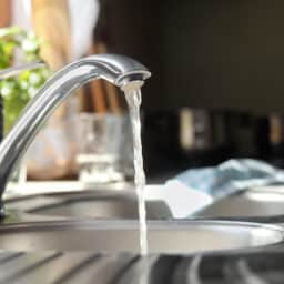 Water running from tap into kitchen sink